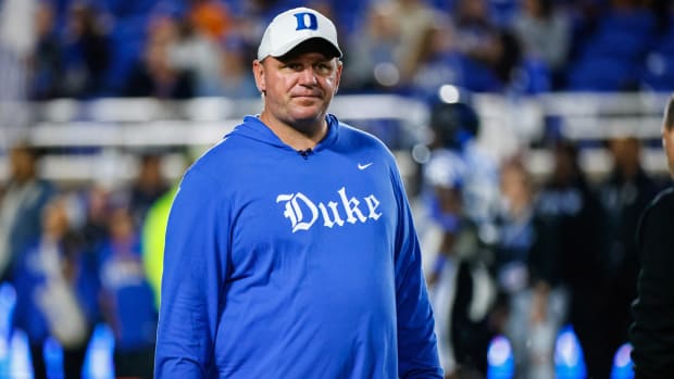 Mike Elko stands in Duke gear on the field